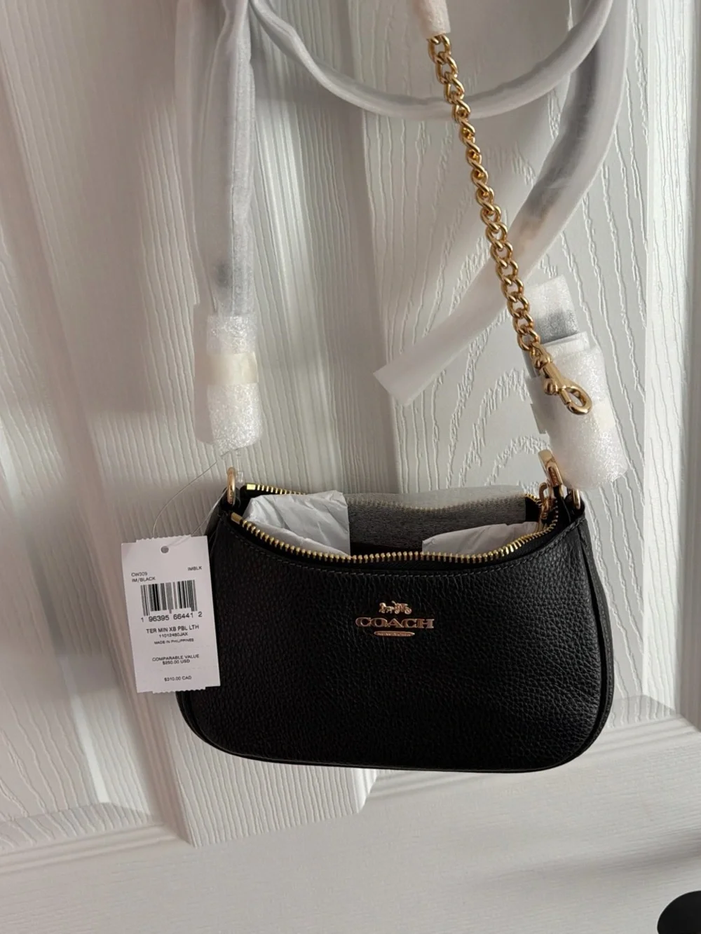 COACH Teri Mini Black Pebbled Leather Shoulder Bag with Gold Hardware.